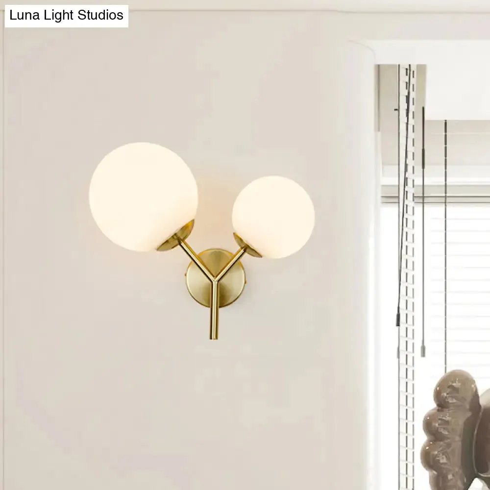 Contemporary White Glass Spherical Sconce with 2 Gold Heads - Wall Mounted Light Fixture